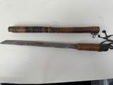 pair of old wooden handled knives on a white surface