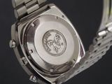 a close up of a watch on a metal bracelet