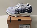 salomo running shoes in a box on top of a table