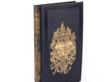 an old book with a gold design on the front of it