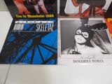 three cd ' s on a table with a woman in a mask on them