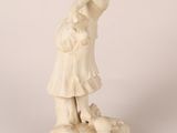 an image of a statue of a woman standing on a rock