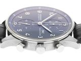 a close up of a wrist watch with a blue dial