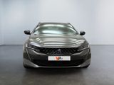 the front view of a grey car in a white room