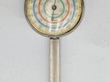 a clock that is on a stick on the wall