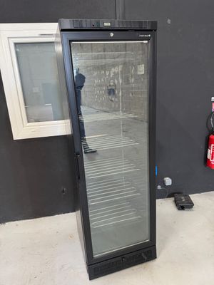 an image of a glass door refrigerator in a room