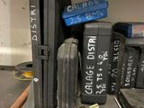 a stack of luggage sitting on a shelf in a garage
