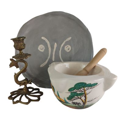 a bowl with a wooden spoon in it next to a bowl with a spoon in it