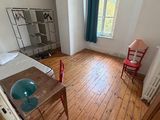 a room with a bed and a desk in it