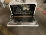 a dishwasher that is open on the floor
