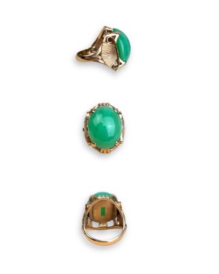 a set of three rings and a ring with a green stone