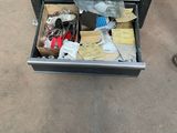 a drawer full of tools on the floor in the garage