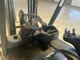 a forklift with a steering and a steering wheel in a warehouse