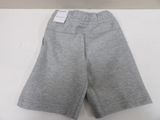 grey sweat shorts with a tag on the side of the shorts