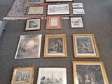 a lot of framed pictures on the floor of this room