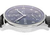 a close up of a watch on a white surface