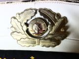 a close up of a hat with a badge on it