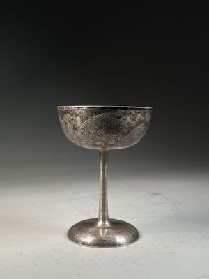 an antique silver goblet sitting on top of a white table