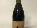 a bottle of wine sitting on top of a white table