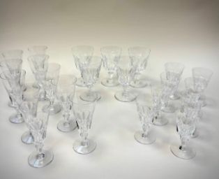 a lot of wine glasses that are sitting on a table