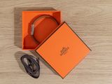 an orange box with a black belt and a black belt in it