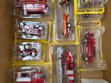 a box with a bunch of toy fire trucks in it