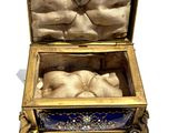 a gold and blue box with a baby inside of it
