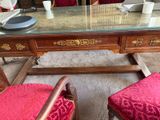 a desk with two chairs and a mirror on it