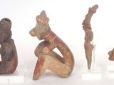 several figurines of different shapes and sizes are displayed on a white surface