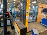 a forklift in a warehouse with lots of pallets