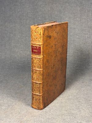 an old book sitting on top of a table next to a gray background