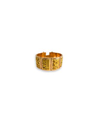 a close up of a gold ring on a white background