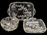 four pieces of glass with a design of flowers and leaves