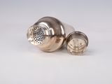 a silver shaker with a metal strainer on it