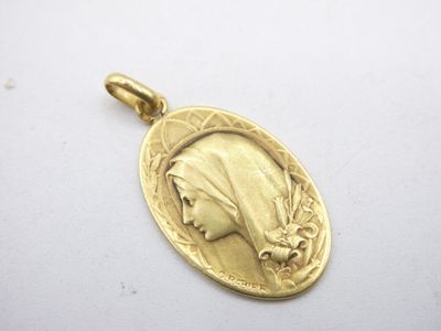 a close up of a gold medal with a woman ' s face on it