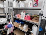 many shelves with cleaning supplies on them in a room
