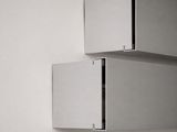 two stainless steel boxes on the wall next to each other