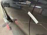 a close up of a car door handle with a sticker on it