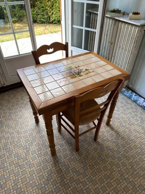 a table and chairs in a room with a tile floor