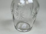 a clear glass vase with a star design on it