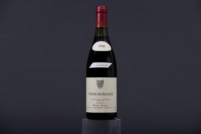 a bottle of red wine sitting on top of a table