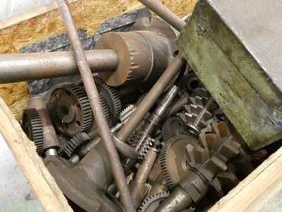 a wooden box filled with various types of gears