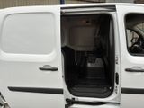 a white van with the door open and the driver ' s seat down