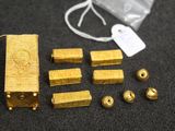 some gold pieces and a bag on a table