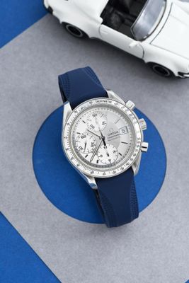 une montre et une petite voiture posées sur une table
