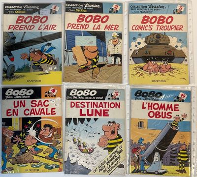 six comic books of various sizes and colors on a white surface
