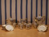 a table that has a lot of cups and saucers on it