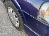 a purple car parked on the side of the road