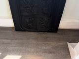 a black fire place in the corner of a room