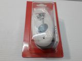 a white remote control in a package on a table